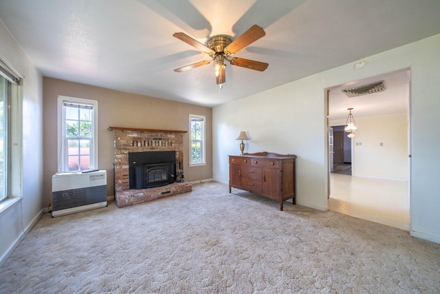 carpeted living room featuring heating unit and ceiling fan