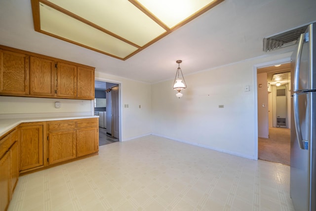 kitchen with stainless steel fridge and decorative light fixtures