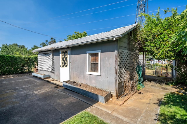 view of property exterior with a patio area