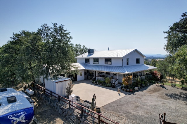 view of front of property featuring a porch and central air condition unit