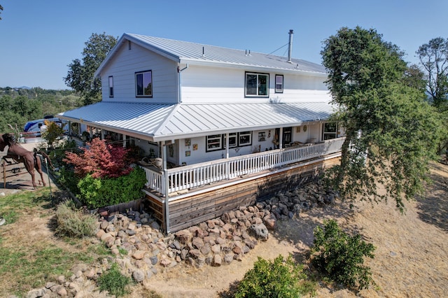 rear view of house with covered porch