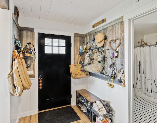 foyer entrance featuring hardwood / wood-style floors and wooden ceiling