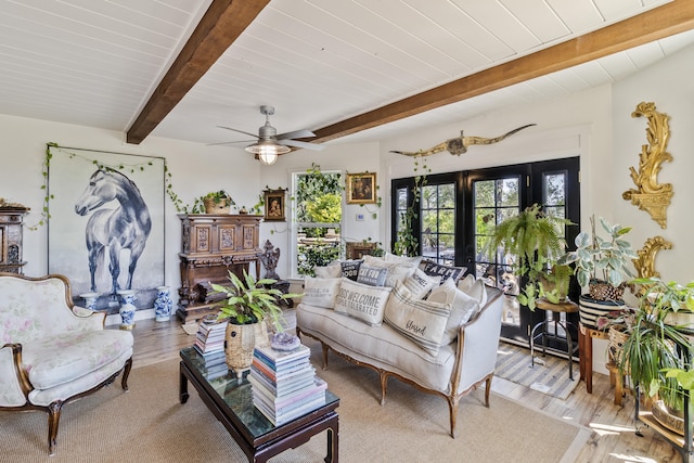 living room with beamed ceiling, ceiling fan, wood ceiling, and light hardwood / wood-style floors