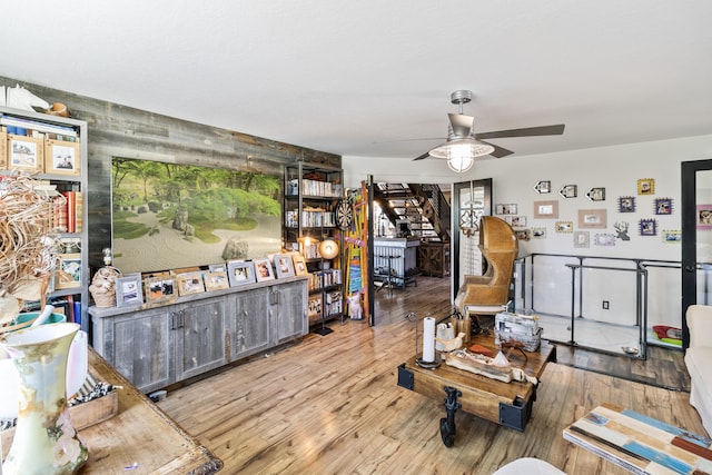 living room featuring ceiling fan and light wood-type flooring