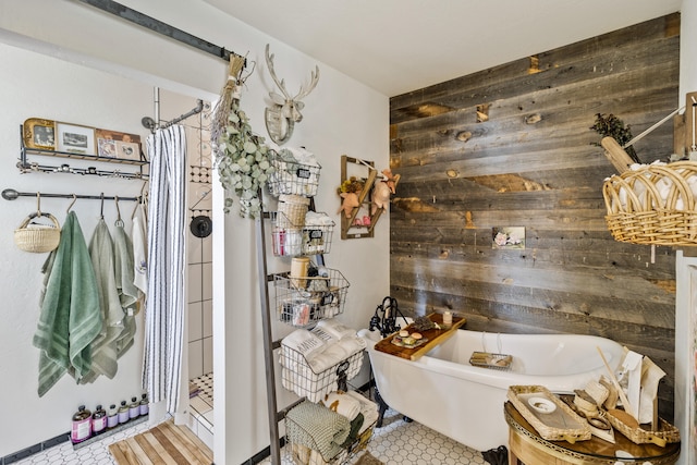 bathroom featuring plus walk in shower, tile patterned floors, and wood walls