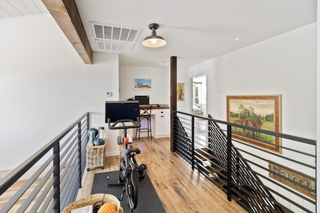 workout room with light hardwood / wood-style flooring