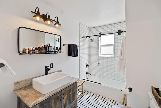 bathroom with vanity and shower / bath combination with glass door