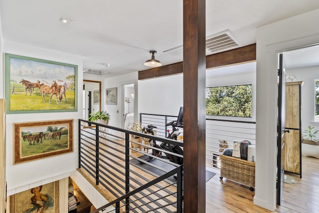 hallway with light hardwood / wood-style floors