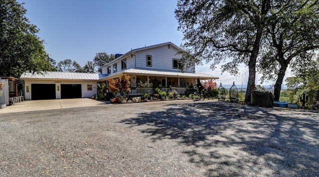 view of front facade featuring a garage and covered porch