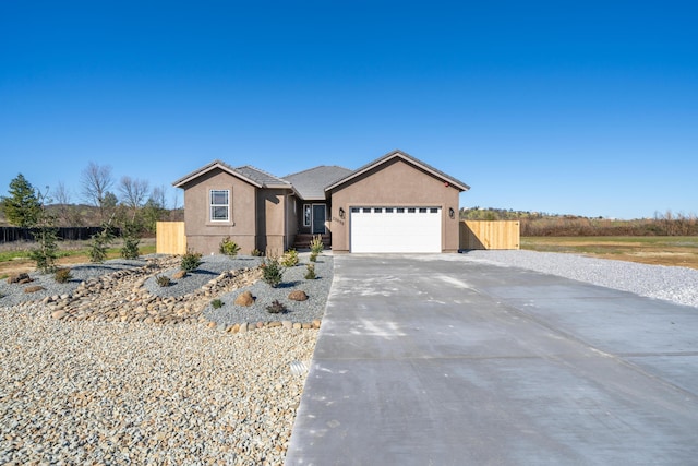 ranch-style house with concrete driveway, a tile roof, an attached garage, fence, and stucco siding