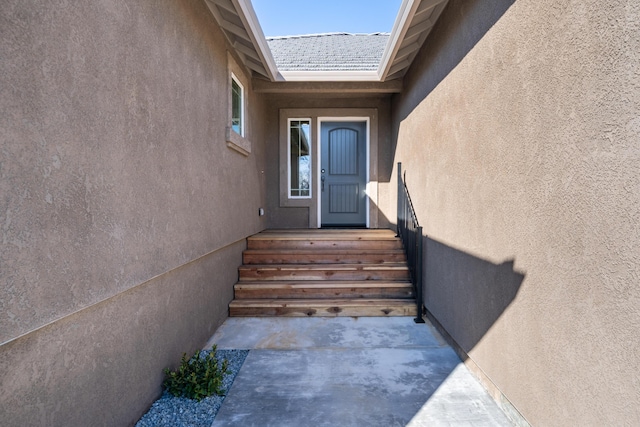 view of exterior entry featuring stucco siding