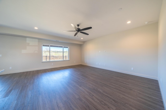 empty room with a ceiling fan, recessed lighting, dark wood finished floors, and baseboards