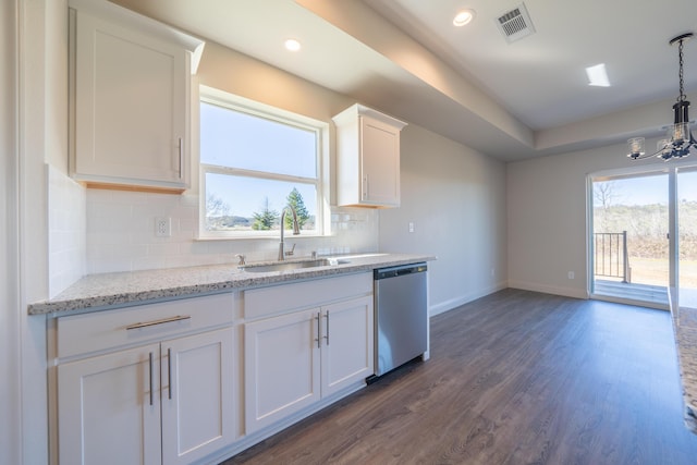 kitchen with visible vents, dark wood finished floors, stainless steel dishwasher, white cabinetry, and a sink