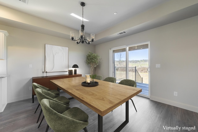 dining space featuring dark wood-type flooring, visible vents, and baseboards