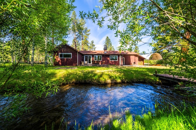 back of property with a water view