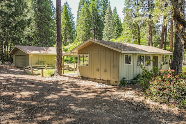 view of property exterior featuring a garage and an outdoor structure