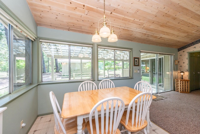 carpeted dining room with a healthy amount of sunlight, lofted ceiling, and wood ceiling