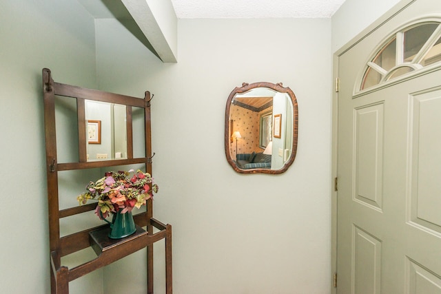 hall with a textured ceiling