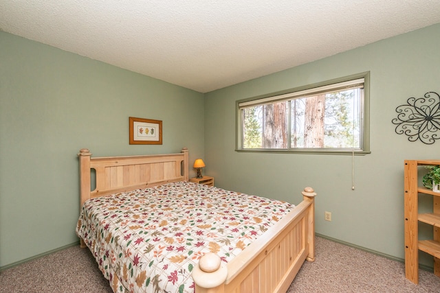 bedroom featuring a textured ceiling and carpet