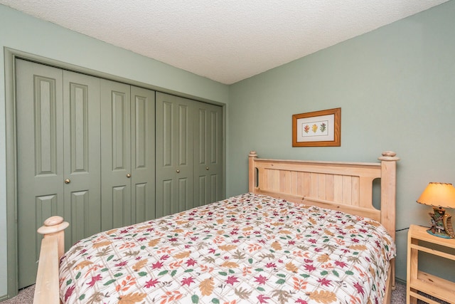 carpeted bedroom featuring a closet and a textured ceiling