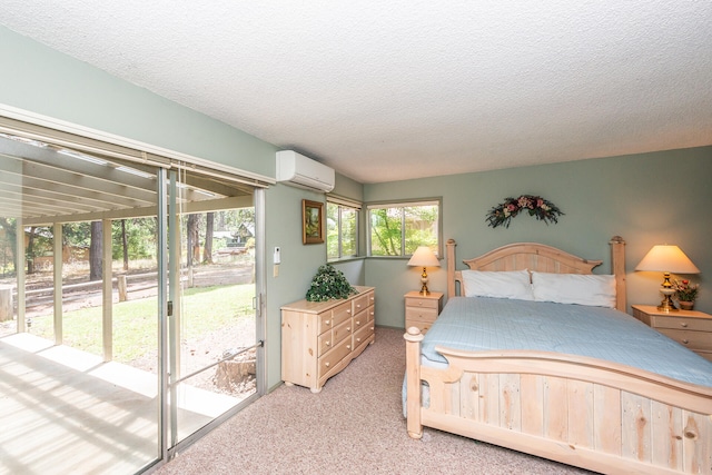 bedroom featuring access to outside, a textured ceiling, carpet, and a wall mounted air conditioner