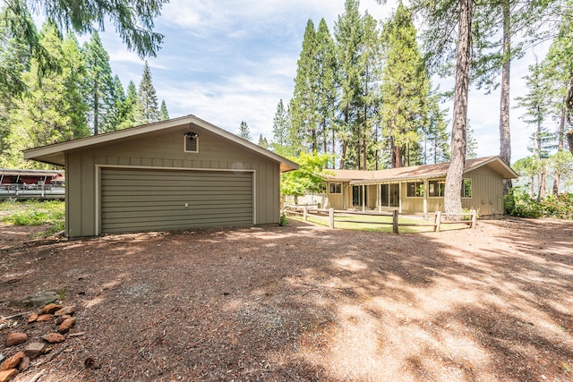 view of front of property featuring an outdoor structure and a garage