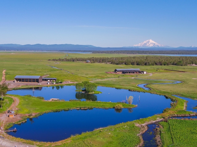 drone / aerial view featuring a water and mountain view and a rural view