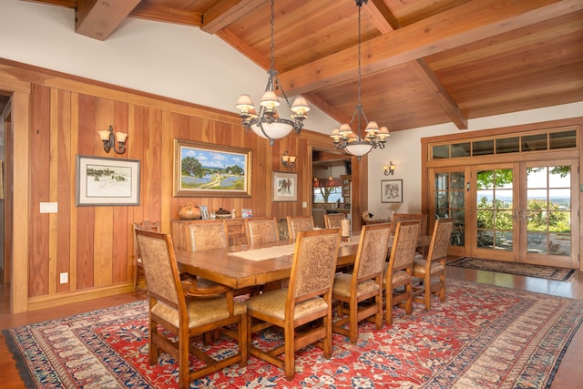 dining area with a chandelier, french doors, hardwood / wood-style flooring, and beam ceiling