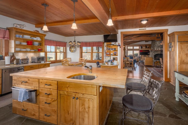 27744 Lee Rd, Mcarthur, CA 96056 - kitchen with beamed ceiling, wooden counters, a sink, stainless steel dishwasher, and wood ceiling