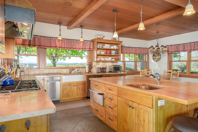 kitchen with beam ceiling, decorative light fixtures, tasteful backsplash, and plenty of natural light