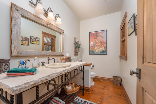 27744 Lee Rd, Mcarthur, CA 96056 - bathroom with baseboards, toilet, vanity, and wood finished floors