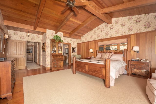 bedroom featuring beam ceiling, hardwood / wood-style flooring, wood ceiling, and ceiling fan