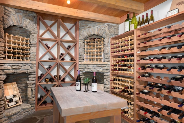 wine room with beamed ceiling and wooden ceiling