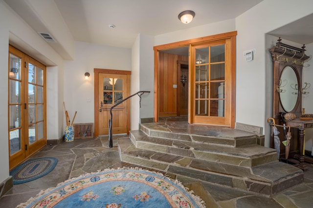 27744 Lee Rd, Mcarthur, CA 96056 - foyer entrance with french doors, baseboards, stone flooring, and visible vents