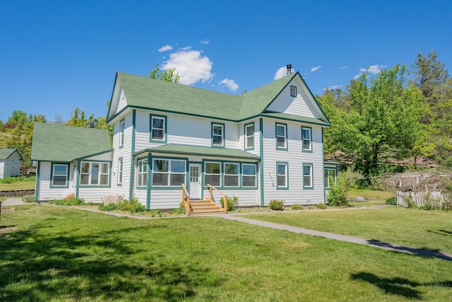 victorian-style house with a front lawn