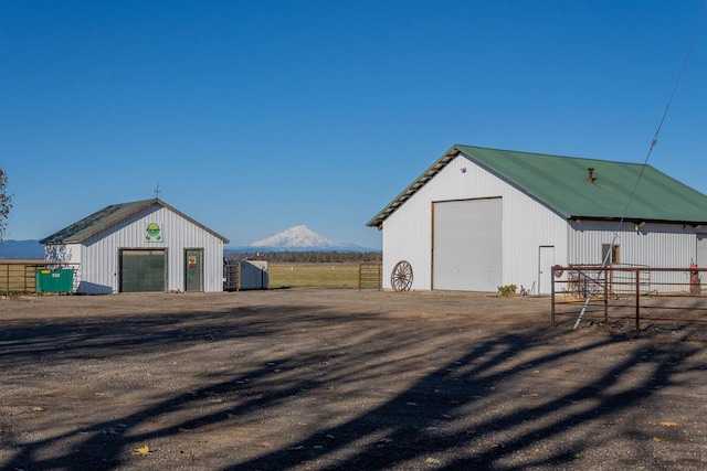 view of outdoor structure featuring a garage and a mountain view