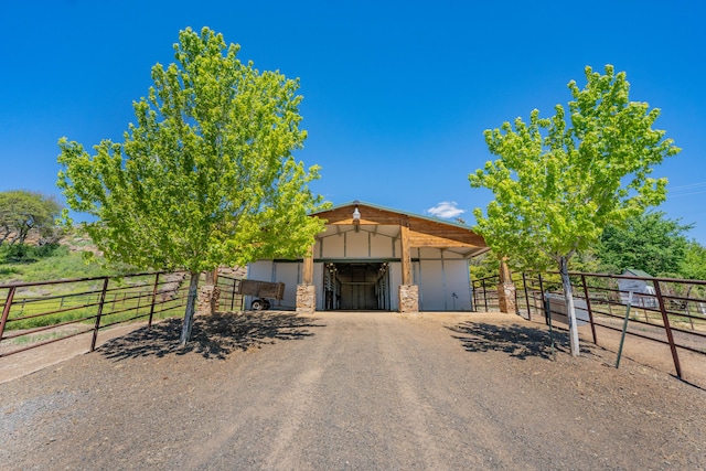 view of stable featuring a rural view and an outdoor structure