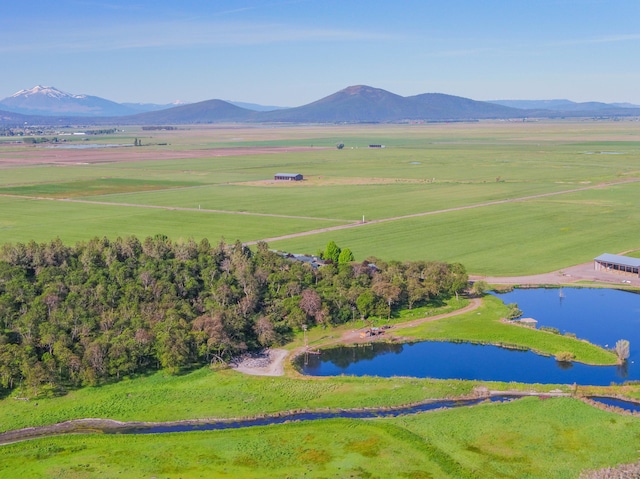 drone / aerial view featuring a water and mountain view and a rural view