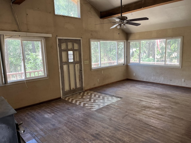 interior space featuring hardwood / wood-style flooring, ceiling fan, and vaulted ceiling with beams