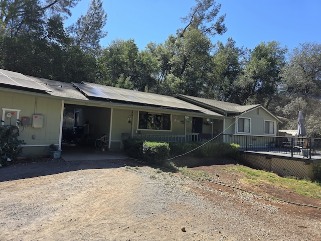 ranch-style house featuring solar panels