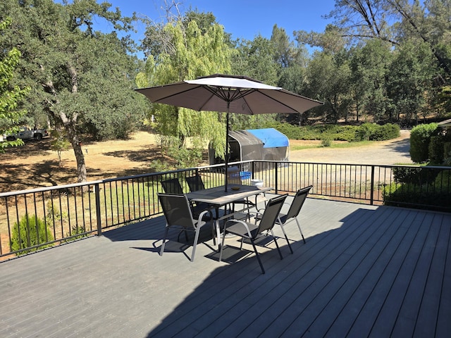 wooden deck with a storage shed