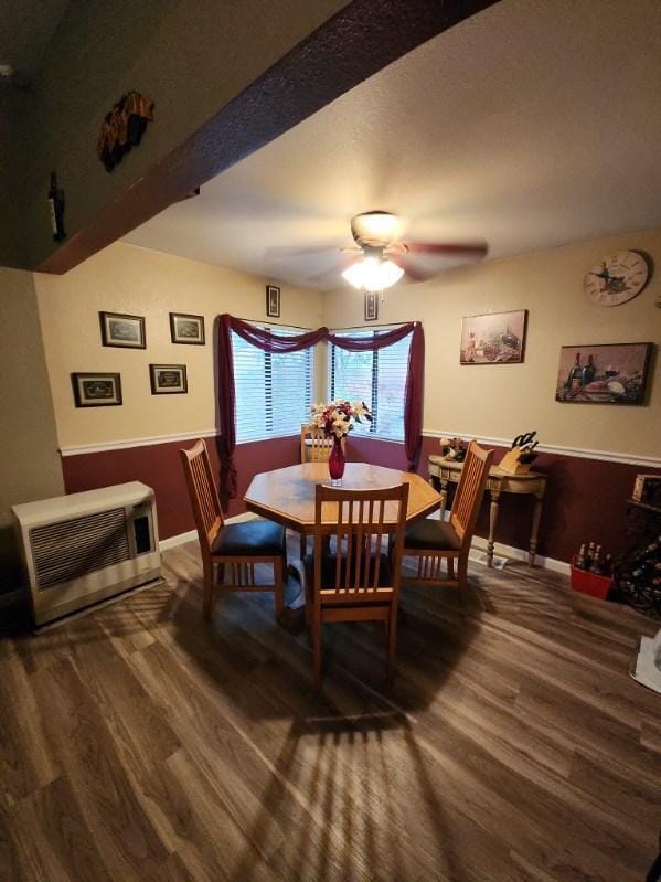 dining room with hardwood / wood-style floors, ceiling fan, and heating unit