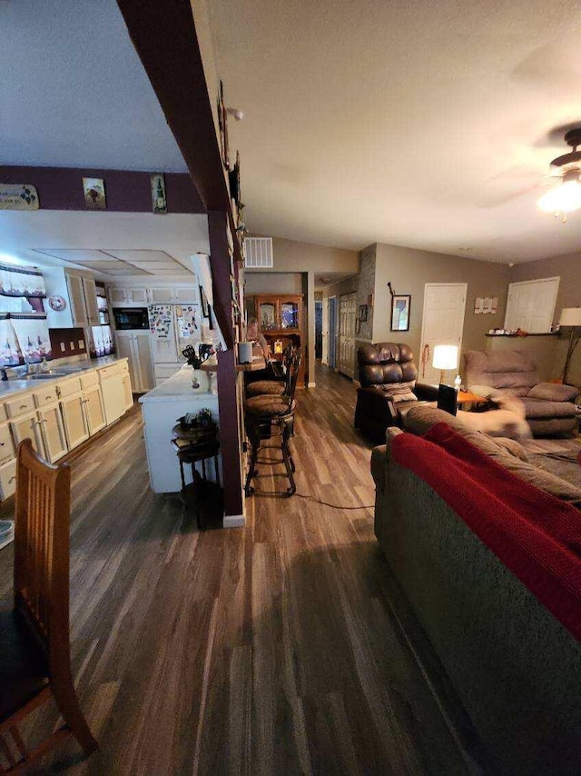 interior space with sink, ceiling fan, and dark hardwood / wood-style floors