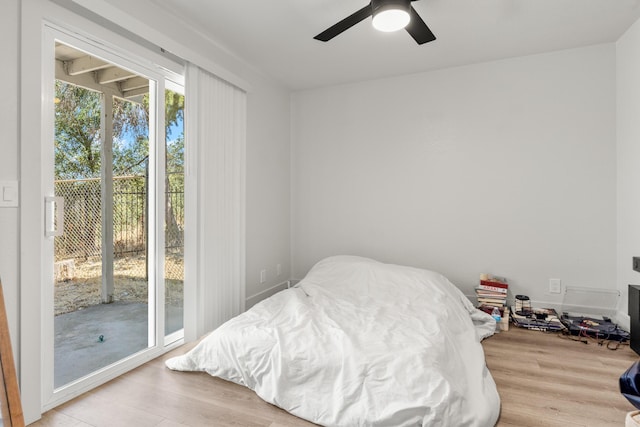 bedroom with ceiling fan, light wood-type flooring, and access to outside