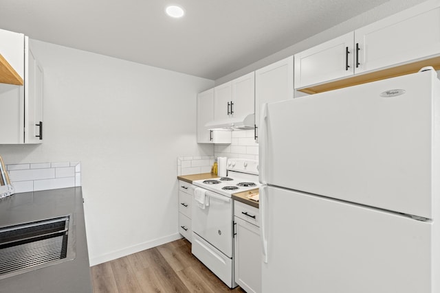 kitchen with decorative backsplash, white appliances, white cabinetry, and light wood-type flooring