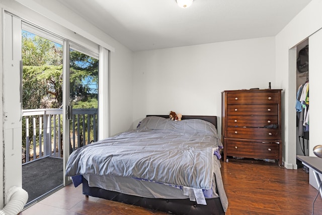 bedroom with multiple windows, dark wood-type flooring, and access to outside