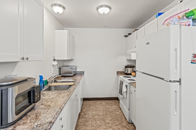 kitchen featuring sink, white appliances, and white cabinetry