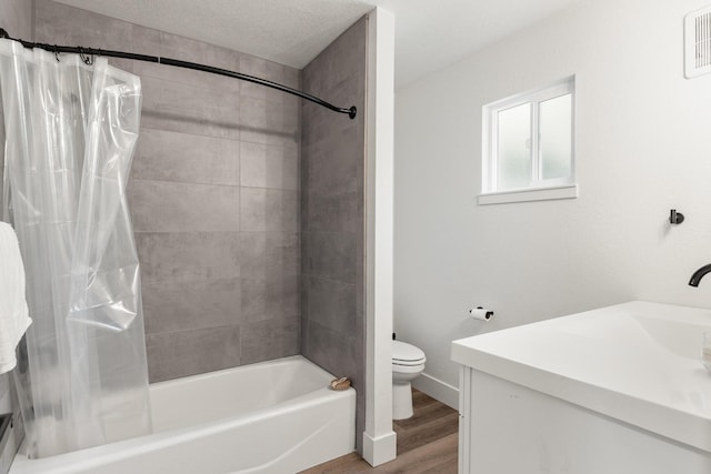 full bathroom with toilet, a textured ceiling, shower / bath combo with shower curtain, hardwood / wood-style floors, and vanity