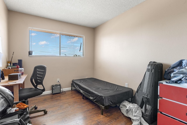 office space featuring a textured ceiling and dark hardwood / wood-style floors