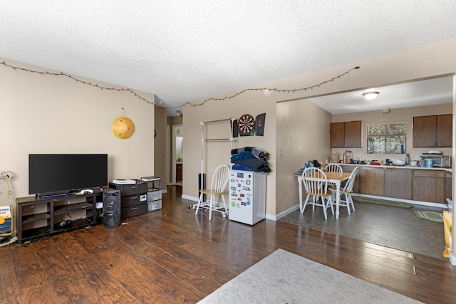 living room featuring a textured ceiling and dark hardwood / wood-style flooring